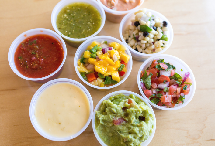 Salsarita's Fresh Mexican Grill - Salsa with toppings, guacamole, and queso.